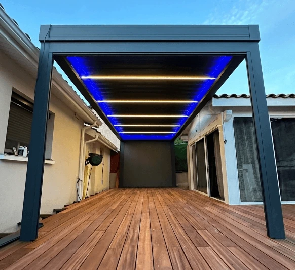 Pergola bioclimatique à lames rétractables installée sur une terrasse moderne, offrant une protection solaire optimale, une ventilation naturelle et un confort extérieur toute l'année.